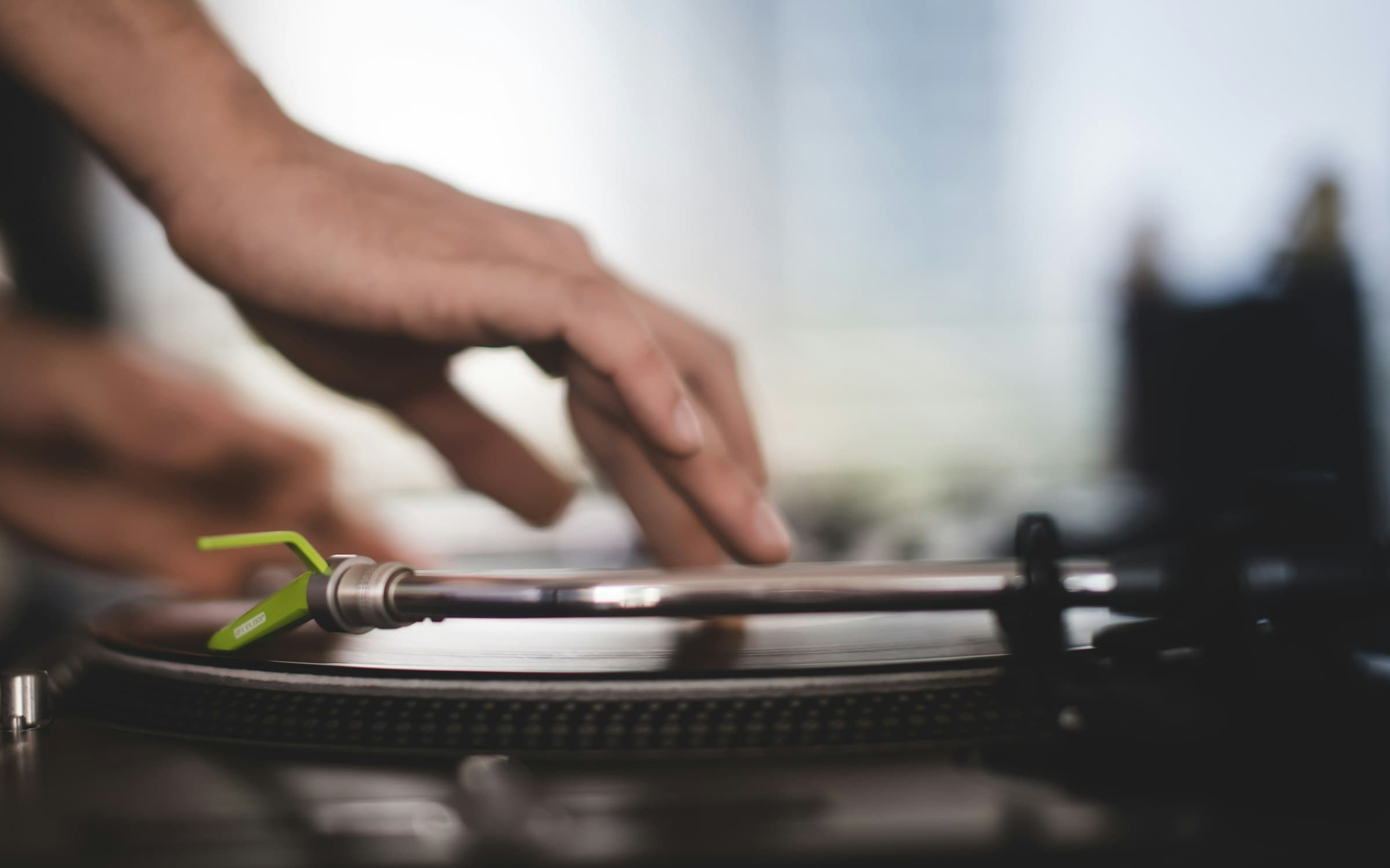 A hand resting on a turntable, shallow focus