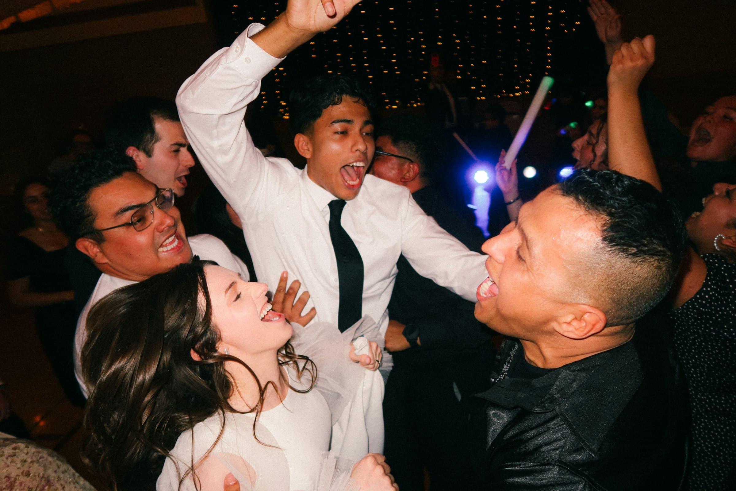 Guests dancing and cheering at a wedding party
